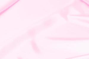 Texture de tissu en satin rose en plastique arrière-plan flou doux photo