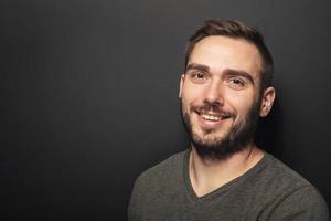 souriant jeune homme aux cheveux noirs. photo