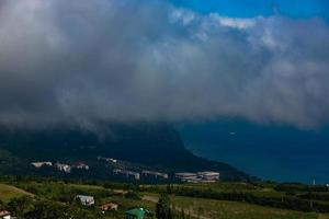 mont ayu dag avec des nuages sur le fond de la mer noire tôt le matin. photo