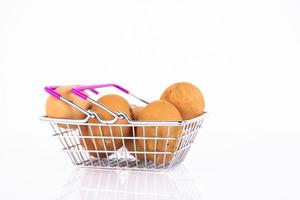 Oeufs de poule beiges et sauvages dans le panier d'un client sur fond blanc. mise au point sélective. espace de copie. photo