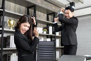 collègues émotifs se battant au bureau. conflit au travail. patron en colère. un homme en tant que patron au bureau est violent envers une femme en tant qu'employée photo