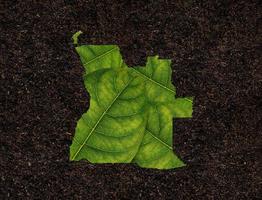 carte de l'angola faite de feuilles vertes, concept écologie carte feuille verte sur fond de sol photo