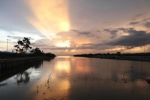 ciel dramatique coloré avec des nuages au coucher du soleil. coucher de soleil dans le lac photo