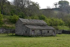Ancienne grange en pierre dans un pâturage en Angleterre photo
