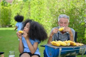 activités de vacances en famille avec grand-père, mère et enfants avec camping. barbecue grill et jouer dans la cour ensemble joyeusement en vacances. photo