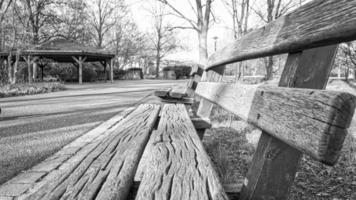 banc de parc en noir et blanc dans le parc. banc en bois. se reposer après une promenade