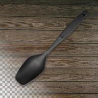 spatule de chef en silicone noir sur fond de bois transparent. photo