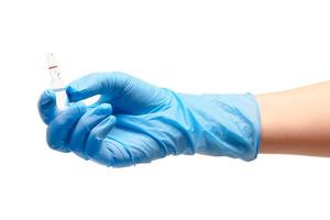 Main de femme médecin en gant chirurgical bleu tenant une ampoule en verre photo