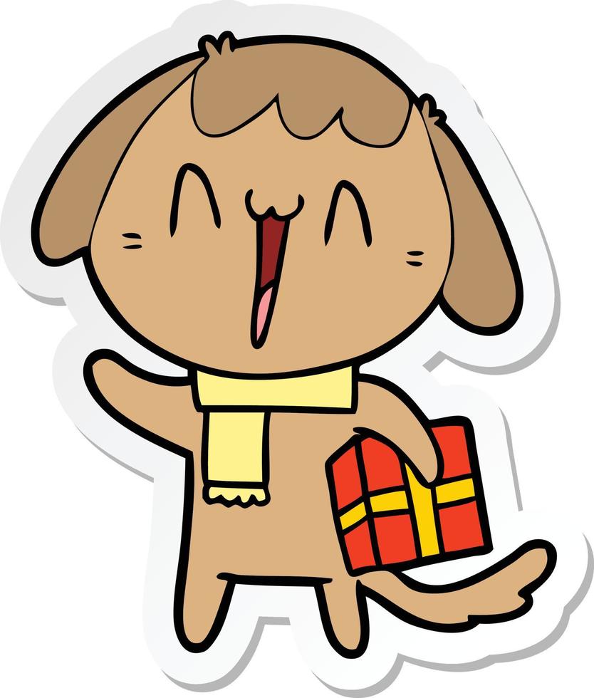 autocollant d'un chien de dessin animé mignon avec un cadeau de Noël vecteur