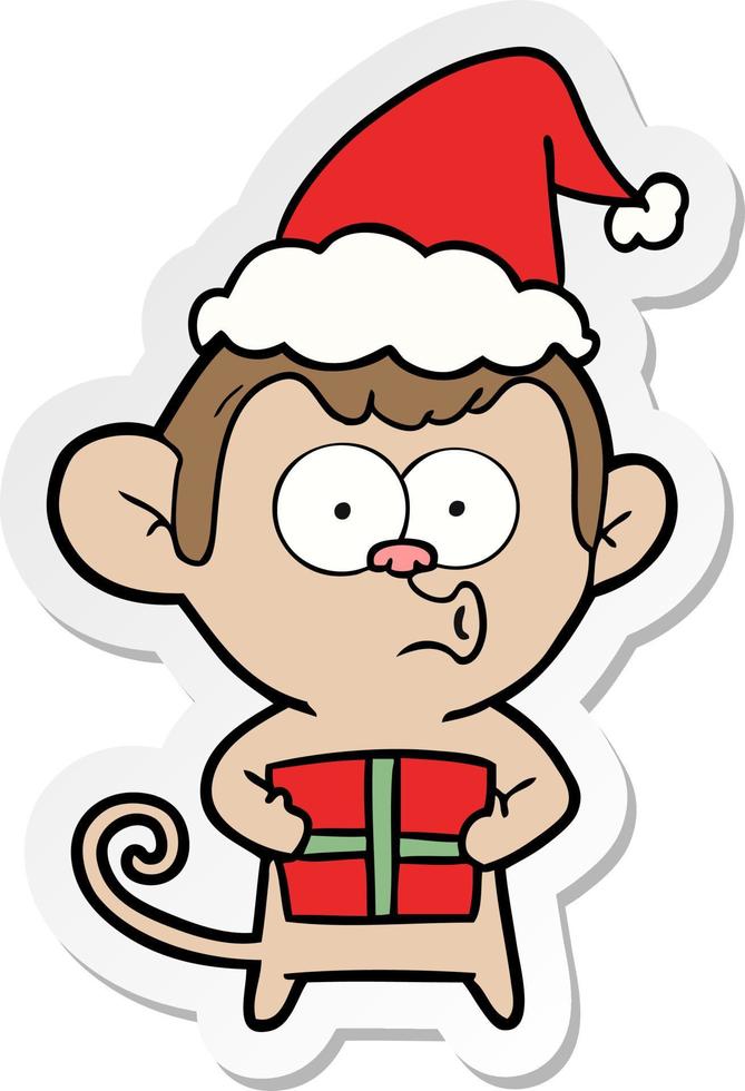 dessin animé autocollant d'un singe de noël portant un bonnet de noel vecteur