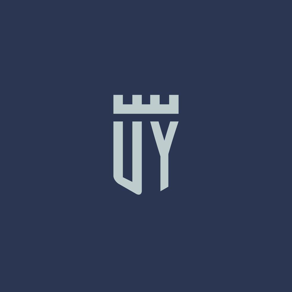 monogramme du logo uy avec un château de forteresse et un design de style bouclier vecteur