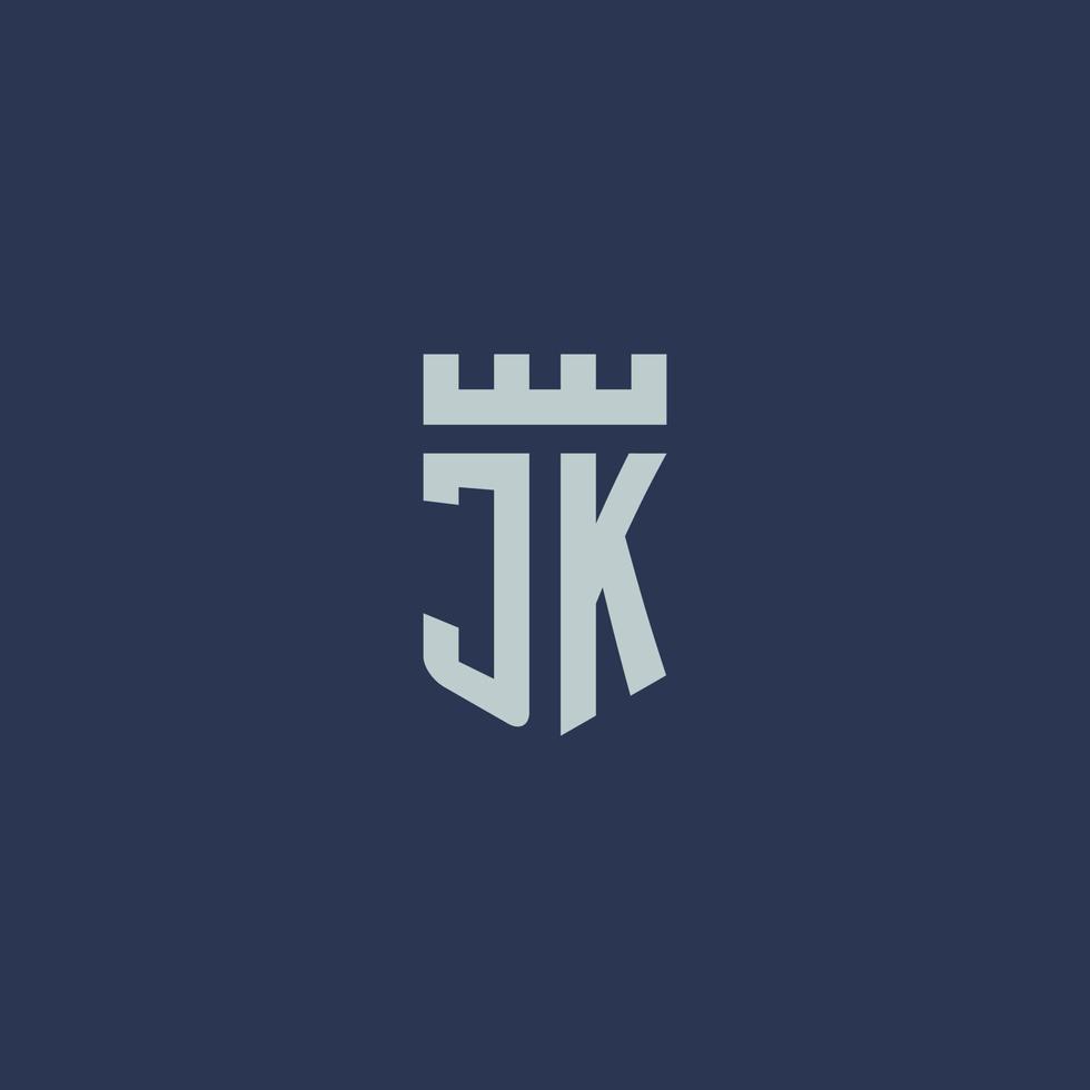 monogramme du logo jk avec un château de forteresse et un design de style bouclier vecteur