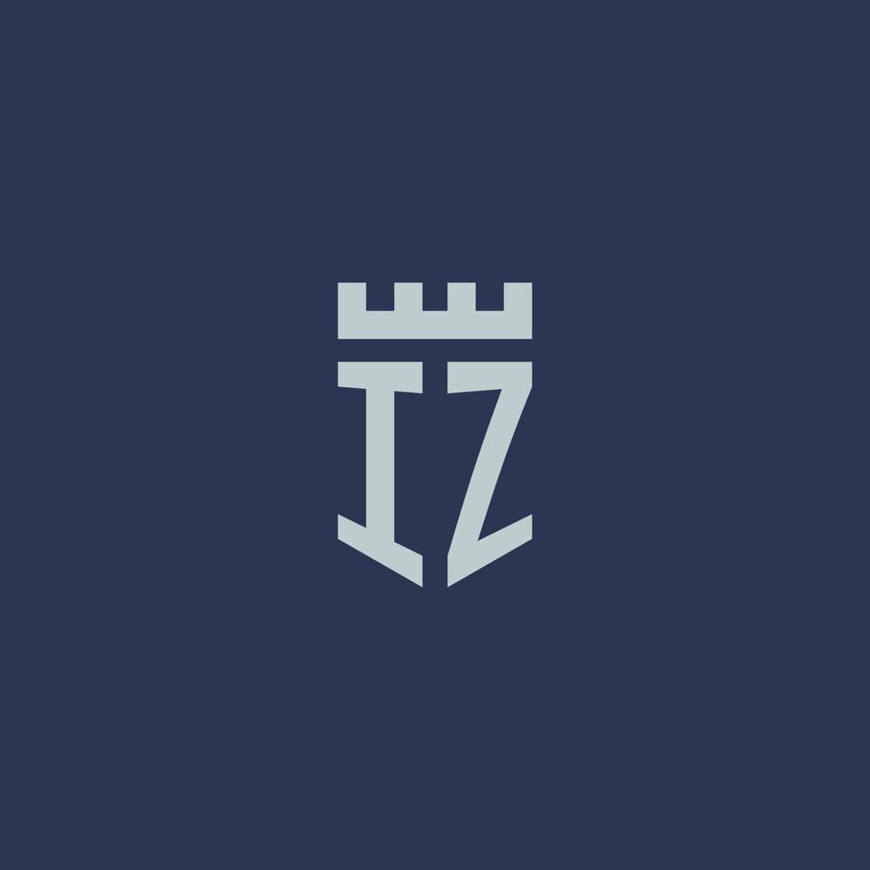 monogramme du logo iz avec un château de forteresse et un design de style bouclier vecteur