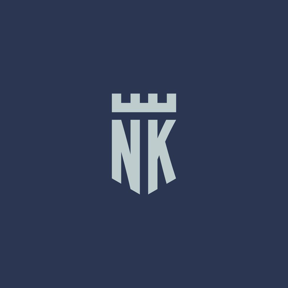 monogramme du logo nk avec un château de forteresse et un design de style bouclier vecteur