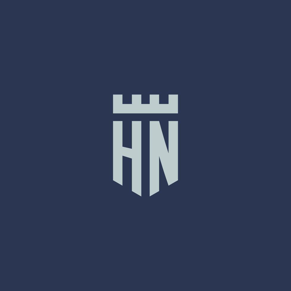 monogramme du logo hn avec un château de forteresse et un design de style bouclier vecteur