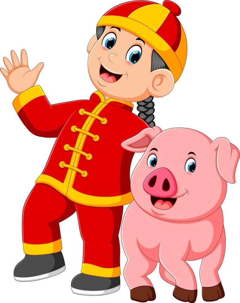 un petit garçon joue avec un gros cochon rose pendant le nouvel an chinois vecteur