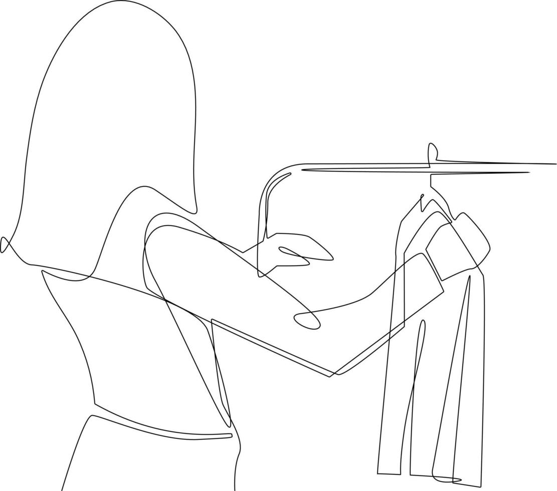 une ligne continue dessinant une femme heureuse debout devant le porte-cintre et essayant de choisir la tenue vestimentaire. notion de vêtements. illustration graphique vectorielle de dessin à une seule ligne. vecteur