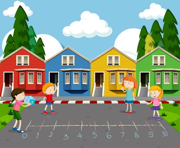 Enfants jouant devant des maisons colorées vecteur
