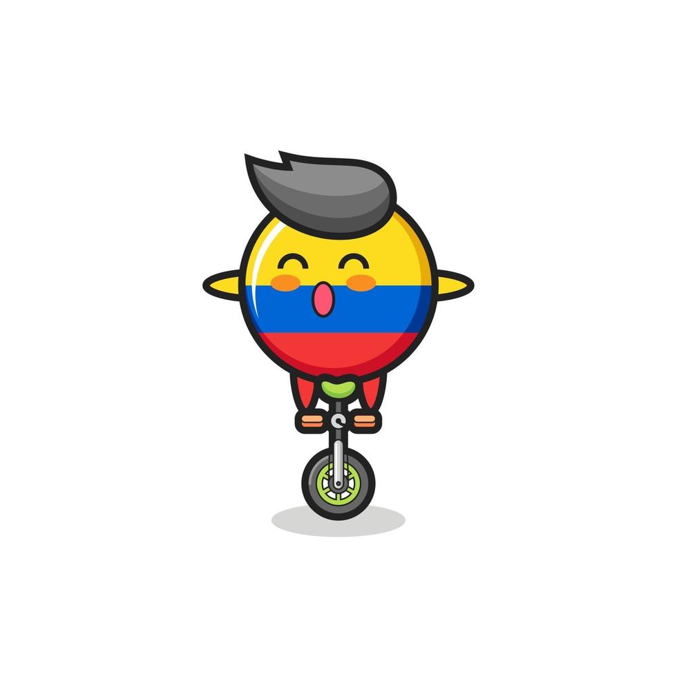 le personnage mignon de l'insigne du drapeau de la colombie fait du vélo de cirque vecteur