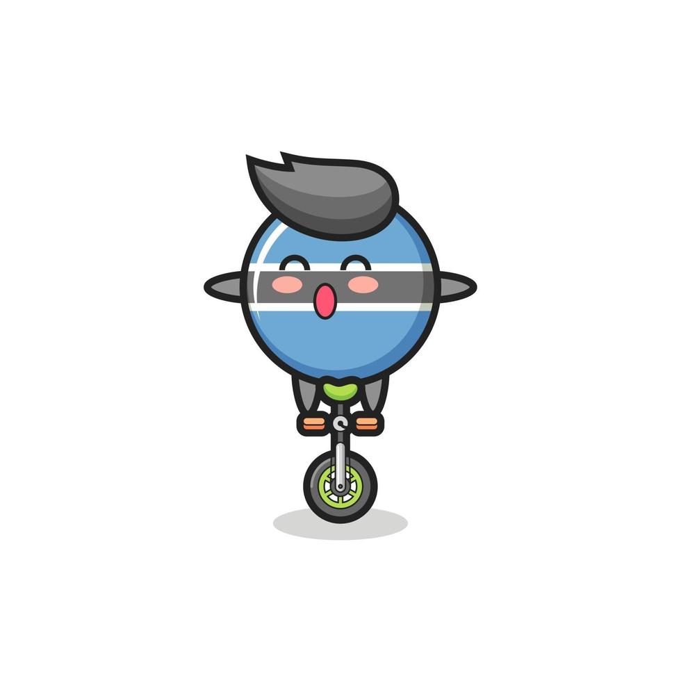 le personnage mignon de l'insigne du drapeau du botswana fait du vélo de cirque vecteur