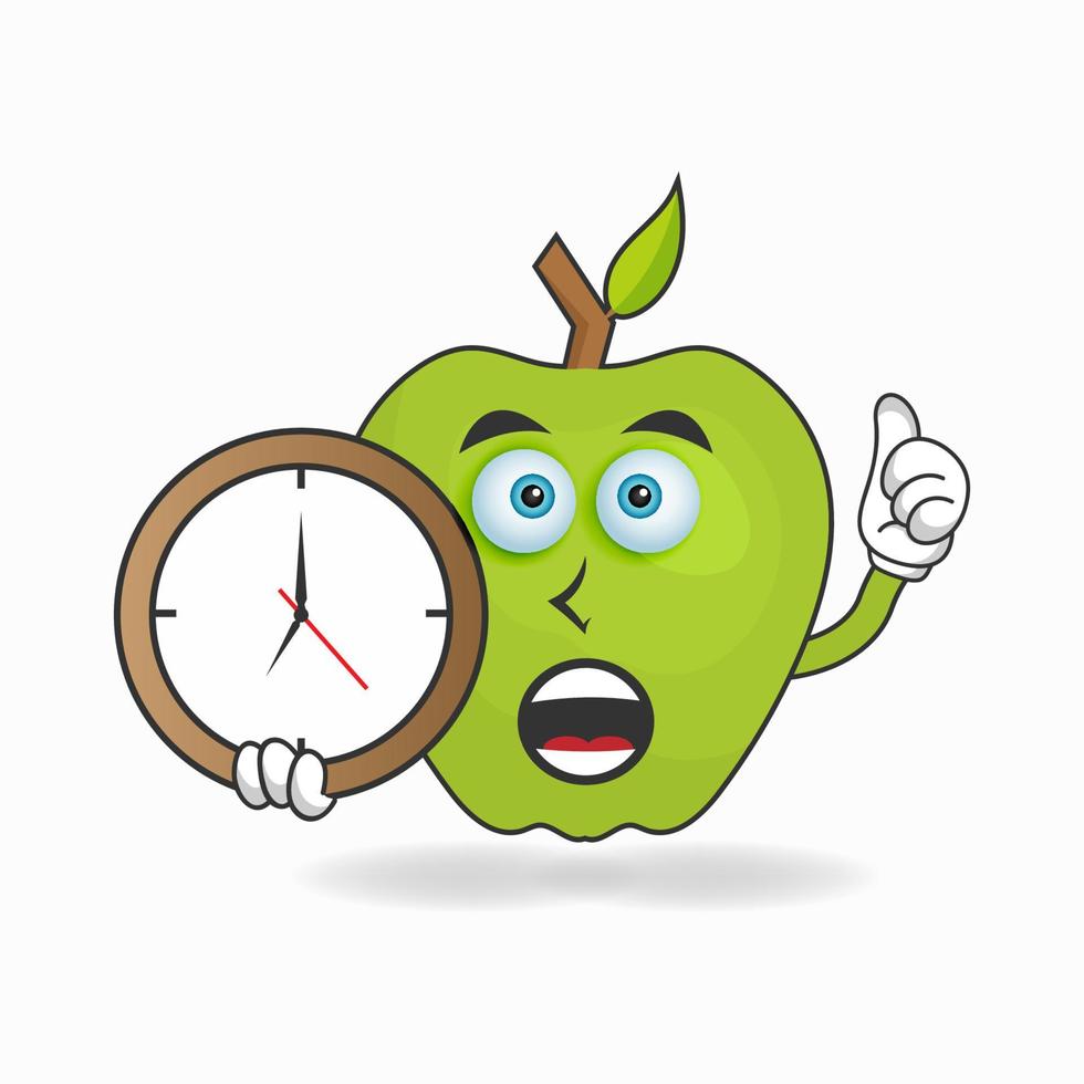 personnage mascotte pomme tenant une horloge murale. illustration vectorielle vecteur