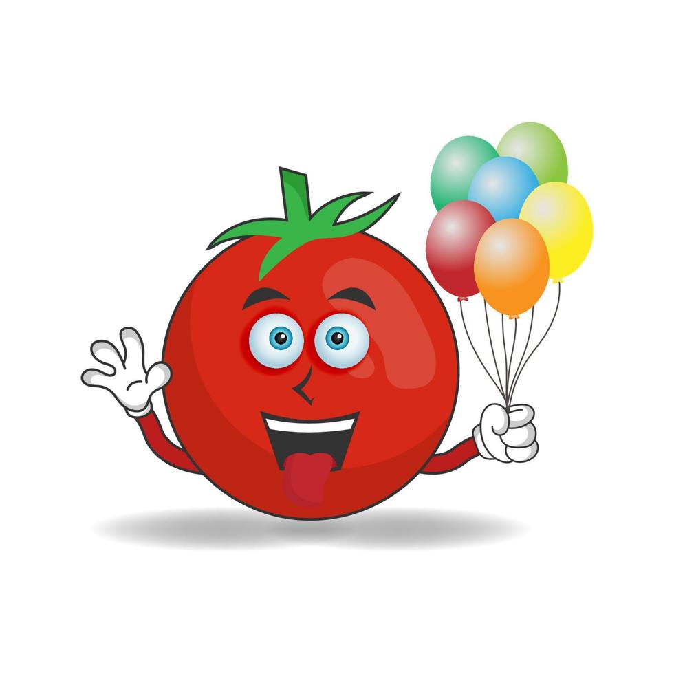 personnage de mascotte de tomate tenant un ballon. illustration vectorielle vecteur