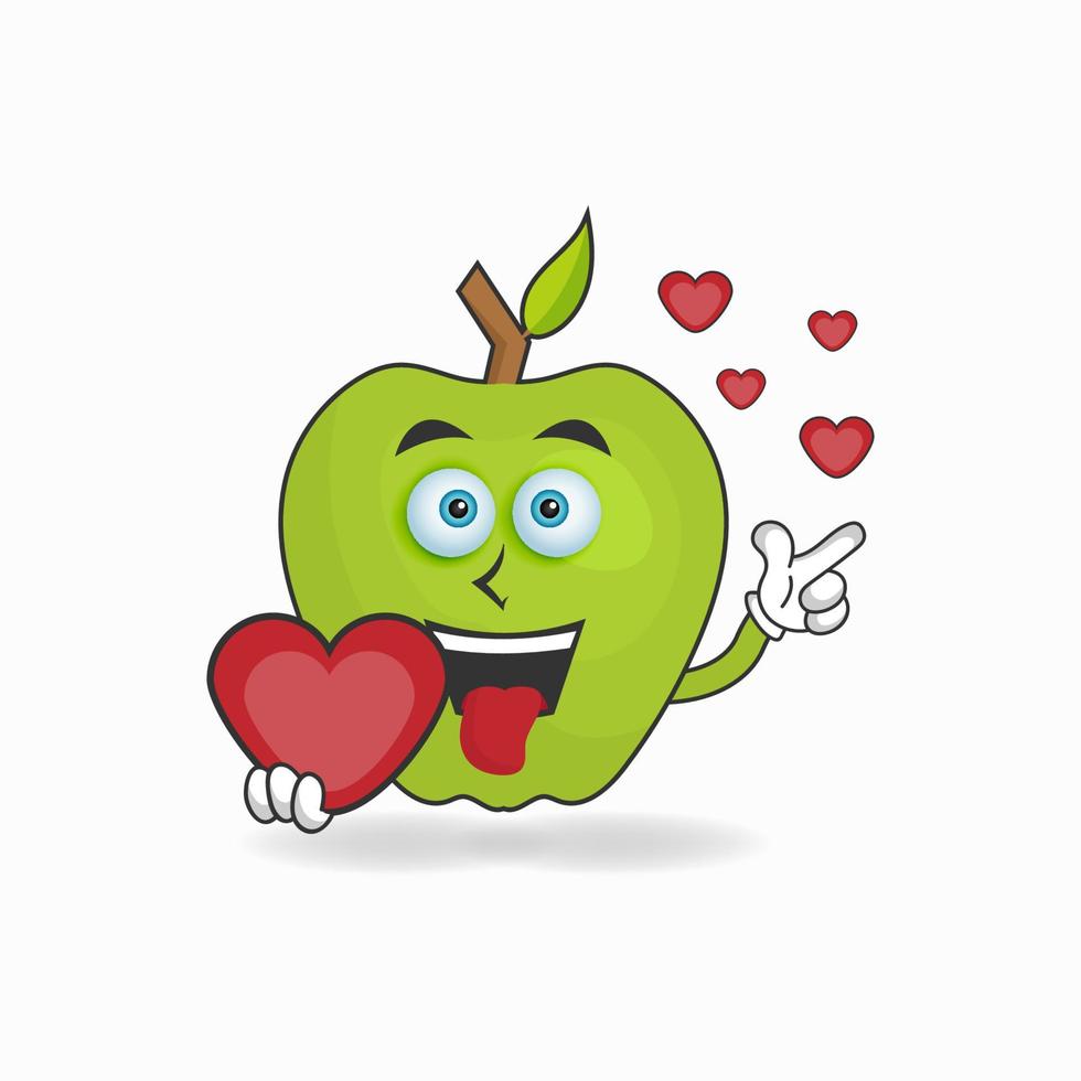 personnage mascotte pomme tenant une icône d'amour. illustration vectorielle vecteur