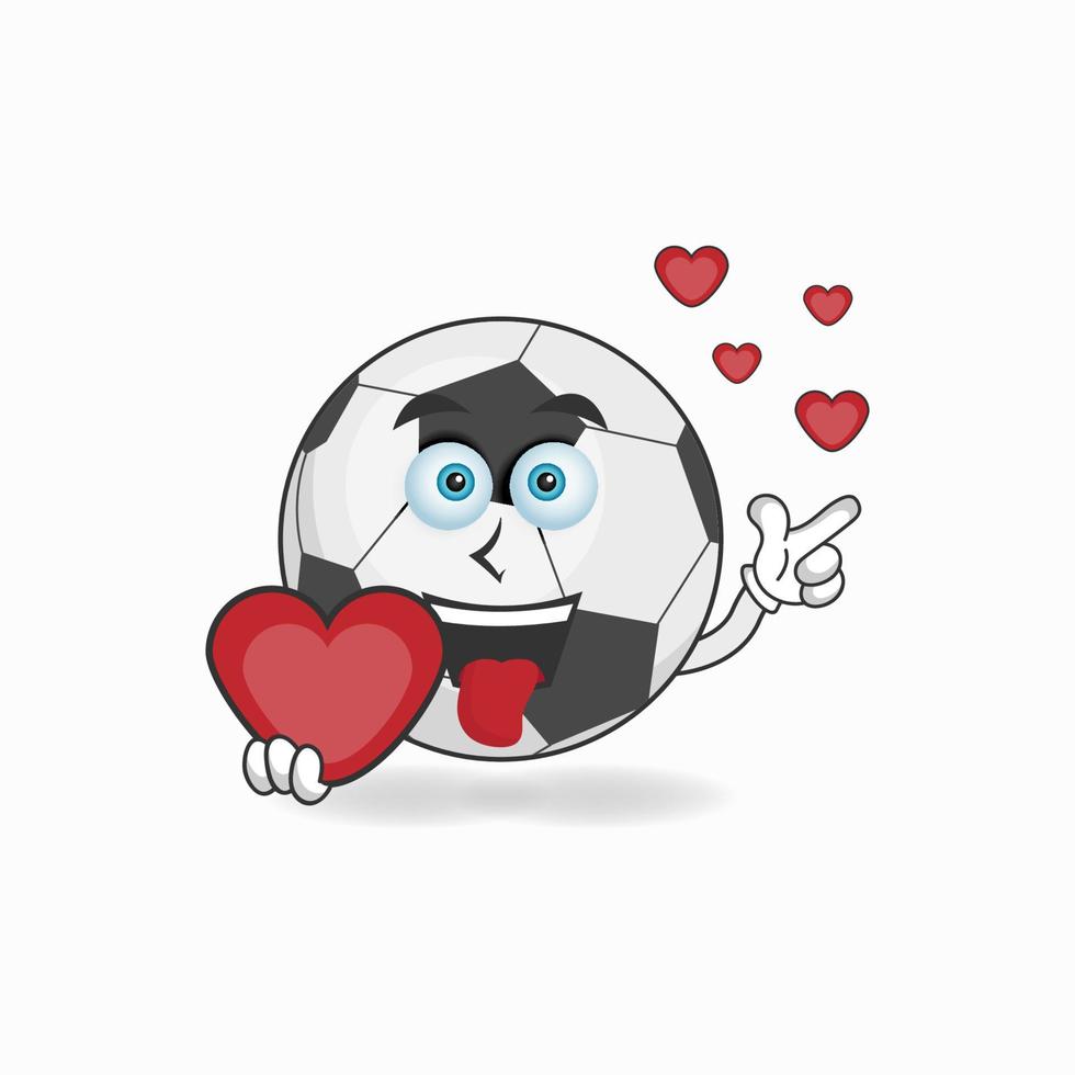 personnage de mascotte de ballon de football tenant une icône d'amour. illustration vectorielle vecteur