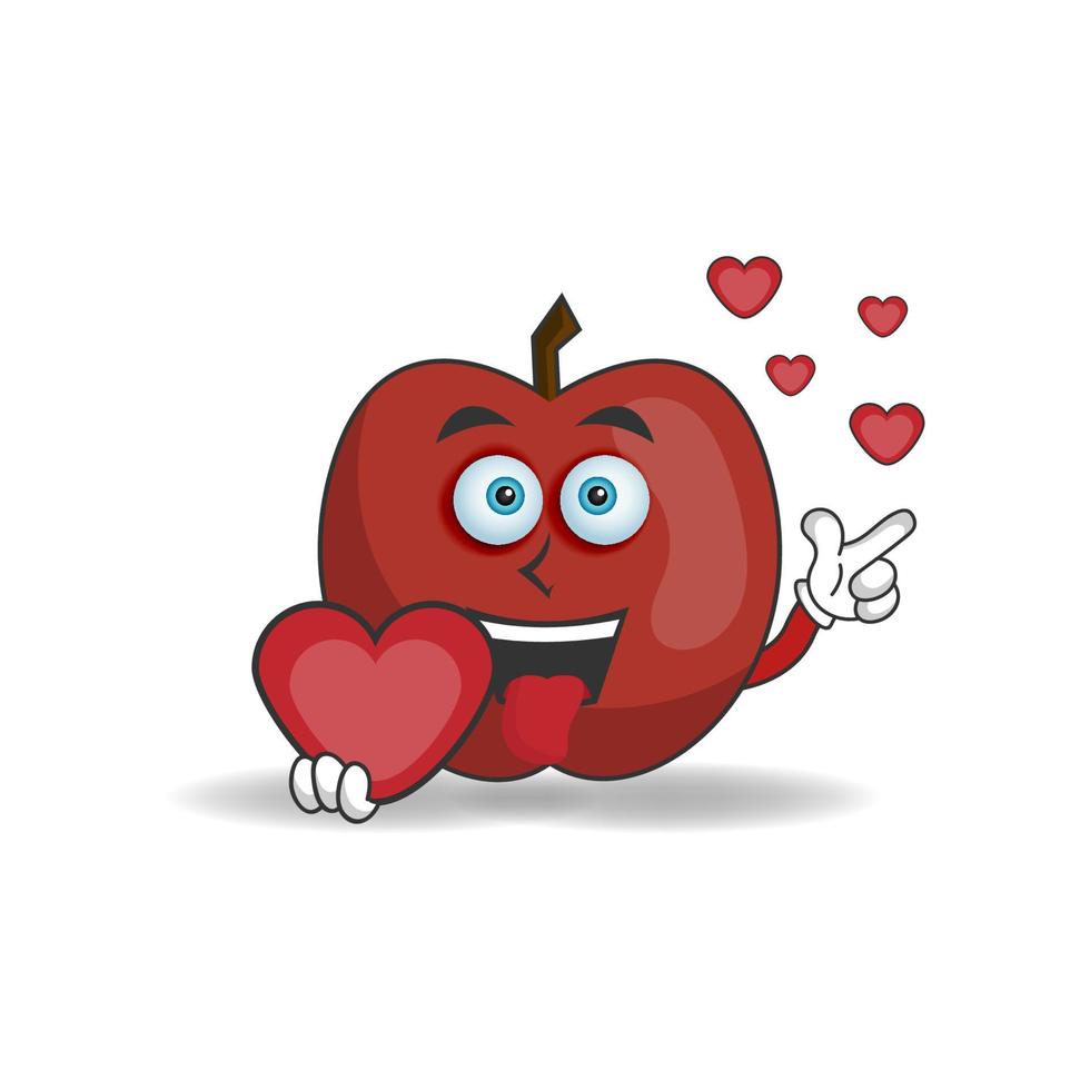 personnage mascotte pomme tenant une icône d'amour. illustration vectorielle vecteur