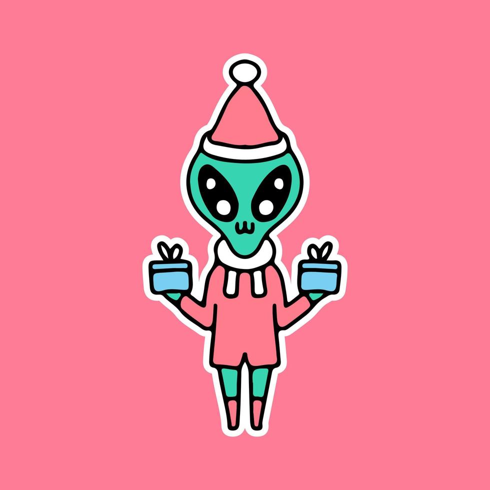 Alien mignon tenant une boîte-cadeau et fêter Noël. dessin animé pour autocollant. vecteur