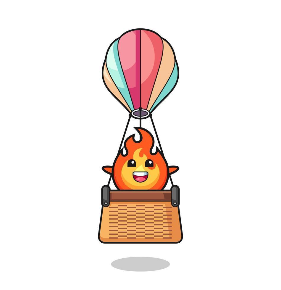 mascotte de feu chevauchant une montgolfière vecteur