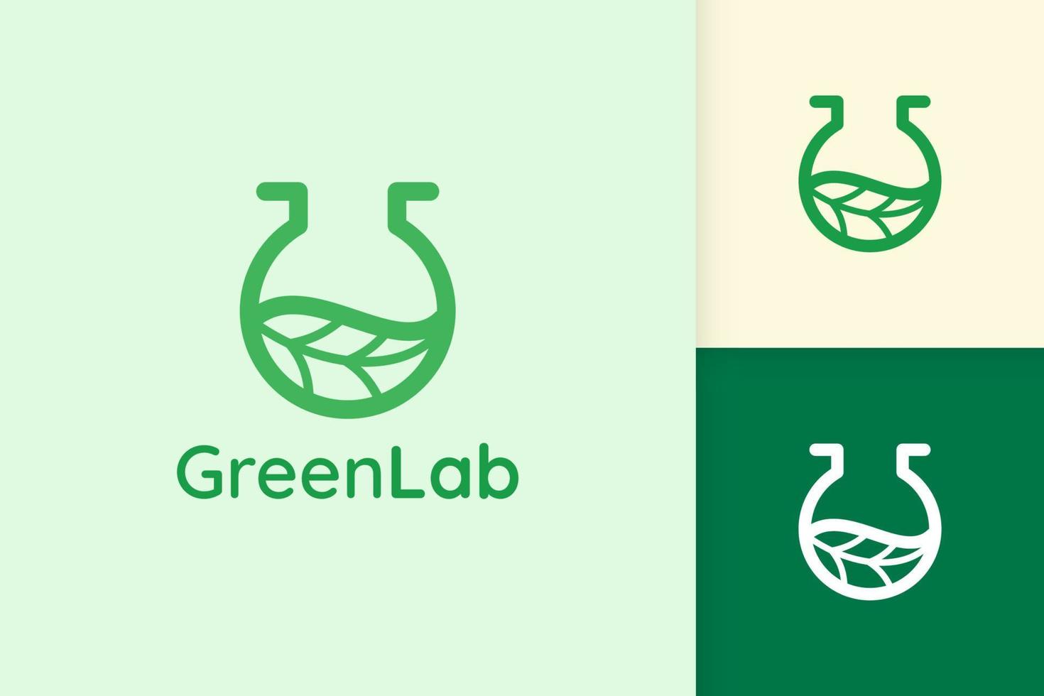 logo de laboratoire vert avec forme de feuille pour la science ou la chimie vecteur
