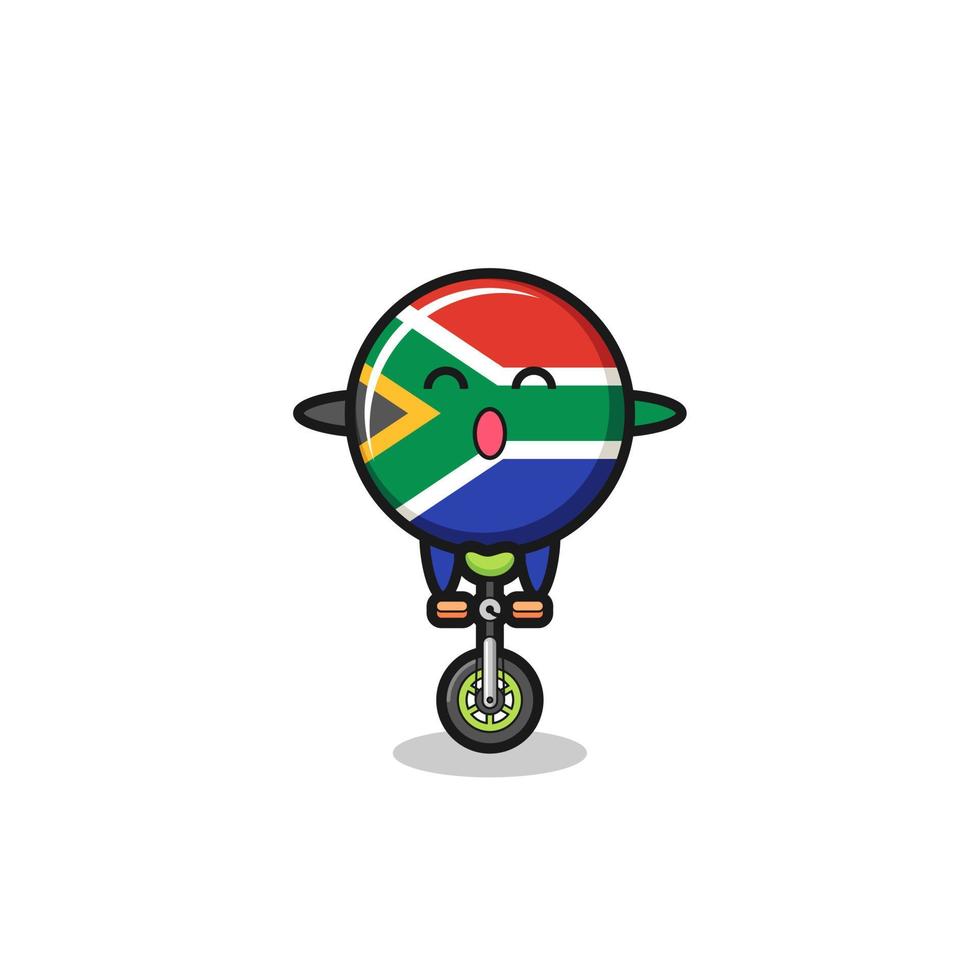 le mignon personnage du drapeau sud-africain fait du vélo de cirque vecteur