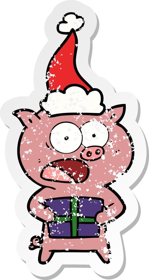 autocollant en détresse dessin animé d'un cochon avec un cadeau de noël portant un bonnet de noel vecteur