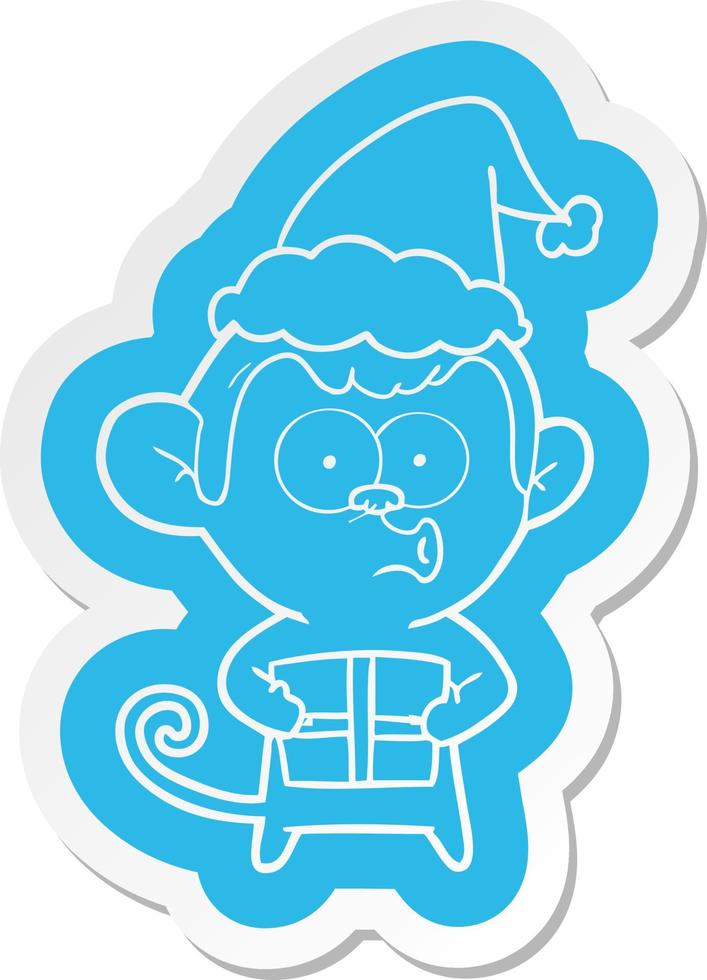 autocollant de dessin animé d'un singe de noël portant un bonnet de noel vecteur