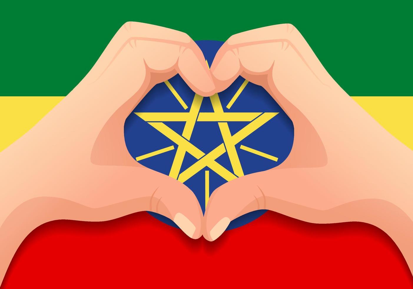 drapeau éthiopien et forme de coeur à la main vecteur