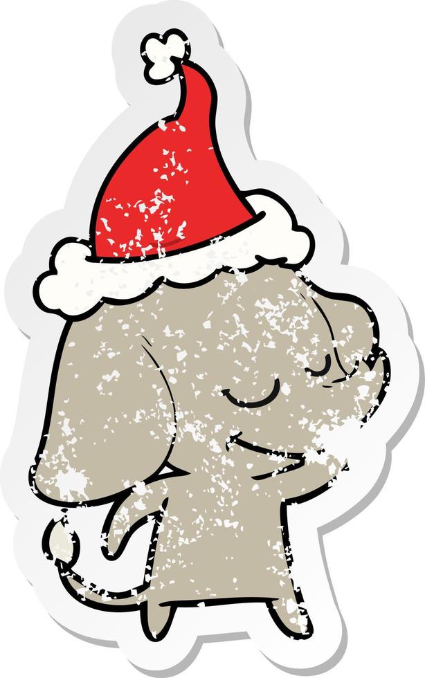 dessin animé autocollant en détresse d'un éléphant souriant portant un bonnet de noel vecteur