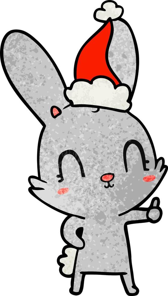 mignon dessin animé texturé d'un lapin portant un bonnet de noel vecteur