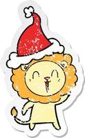 caricature d'autocollant en détresse de lion qui rit d'un bonnet de noel vecteur