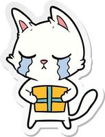 autocollant d'un chat de dessin animé qui pleure tenant un cadeau de noël vecteur
