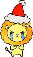 caricature texturée d'un lion qui pleure portant un bonnet de noel vecteur