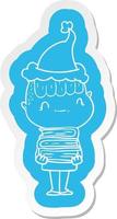 autocollant de dessin animé d'un garçon sympathique avec des livres portant un bonnet de noel vecteur