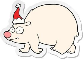 dessin animé autocollant d'un ours polaire marchant portant un bonnet de noel vecteur