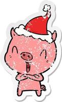 dessin animé autocollant en détresse heureux d'un cochon portant un bonnet de noel vecteur