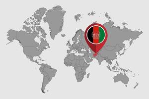 épingler la carte avec le drapeau de l'afghanistan sur la carte du monde. illustration vectorielle. vecteur