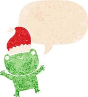 grenouille de dessin animé mignon portant un chapeau de noël et une bulle de dialogue dans un style texturé rétro vecteur