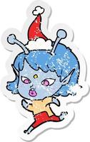 dessin animé autocollant assez affligé d'une fille extraterrestre courant portant un bonnet de noel vecteur