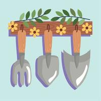 outils de jardinage suspendus avec des fleurs vecteur