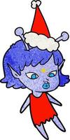 joli dessin animé texturé d'une fille extraterrestre portant un bonnet de noel vecteur