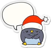 pingouin de dessin animé mignon portant un chapeau de noël et un autocollant de bulle de dialogue vecteur